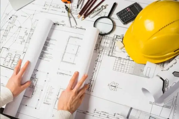 Architectural blueprints with construction tools symbolizing precision and planning