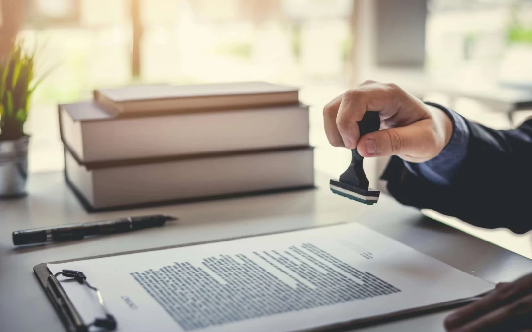 Certified translation document being stamped on a desk with legal books and paperwork in the background.