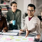 Professional Translation and Localization Team | PSP Languages – PSP Languages Professional multilingual team collaborating on global language translation and localization project at a corporate office