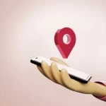 3D illustration of a hand holding a smartphone with a floating location pin, representing software localization, regional app customization, and location-based user experiences.