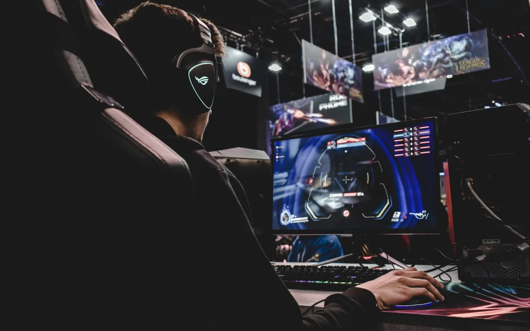 Person gaming at esports event with League of Legends banners in background
