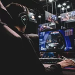 Immersive Esports Gaming Experience – PSP Languages Person gaming at esports event with League of Legends banners in background