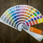 Pantone color swatch guide displaying a wide range of color samples used in branding, graphic design, and multilingual marketing materials. Show more lines